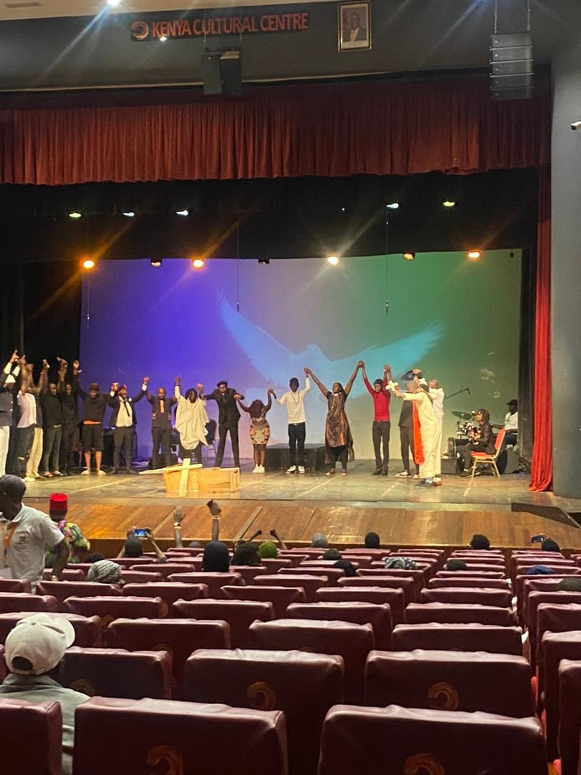 Theater performance finale at Kenya Cultural Centre showcasing teamwork and stage lighting.