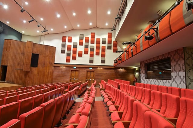 Kenya Cultural Centre theater with modern red seating and acoustic paneling for events.