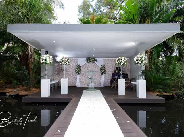 Outdoor wedding venue with elegant decor and lush greenery at The Forum.