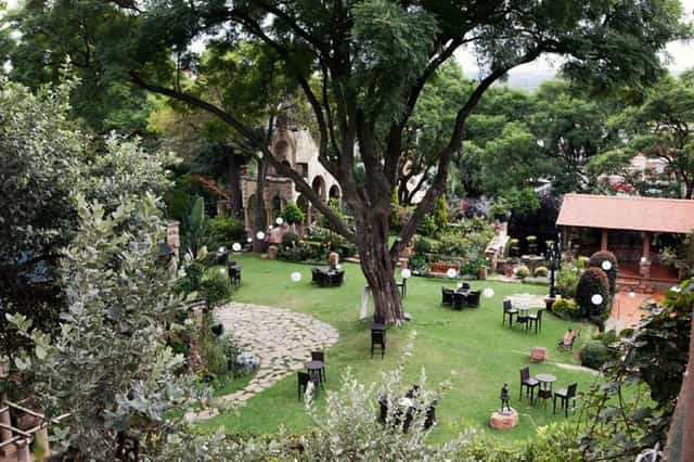 Charming outdoor garden venue with lush greenery for weddings and events in The Forum.