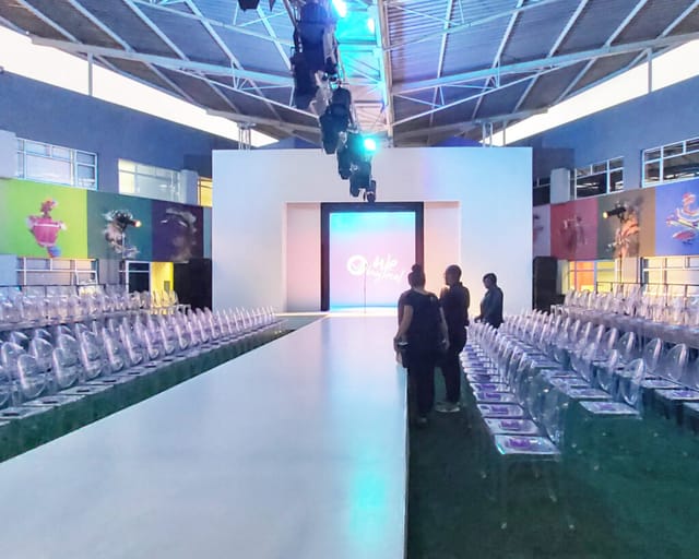 Dar Es Salaam Boardroom runway setup with transparent chairs for a stylish fashion show.
