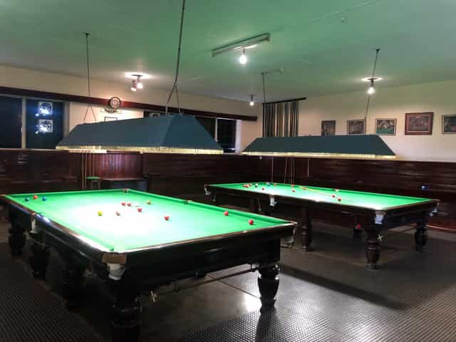 Bullseye Bar at Nairobi Gymkhana with snooker tables for team-building events.
