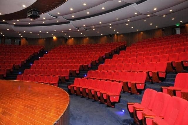 Great Court auditorium at University of Nairobi with red seats, ideal for conferences.