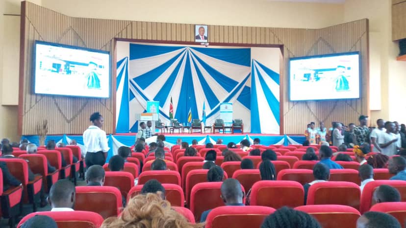 Event-ready Taifa Hall with red chairs and large screens for conferences at University of Nairobi.