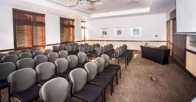 Conference venue in Montecasino with gray chairs, ideal for workshops and meetings.