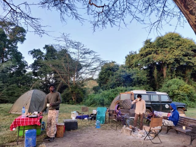 Public Campsites at Lake Nakuru: Tents and cozy fire for team-building retreat.