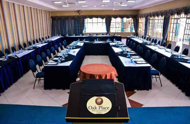 Conference room with U-shaped seating at Oak Place Hotel for meetings and workshops.