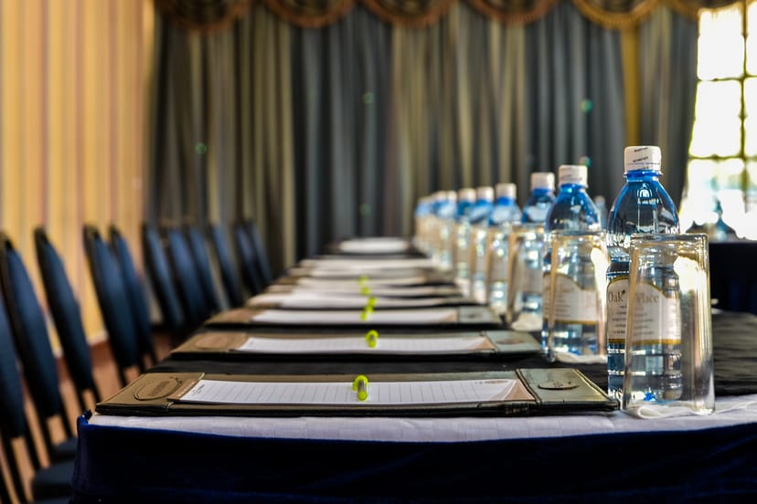Conference room at Oak Place Hotel, featuring a long table for meetings and events.