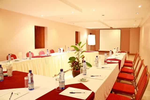 Blue Carpet Conference Room with U-shaped table for meetings and workshops at Hennessis Hotel.