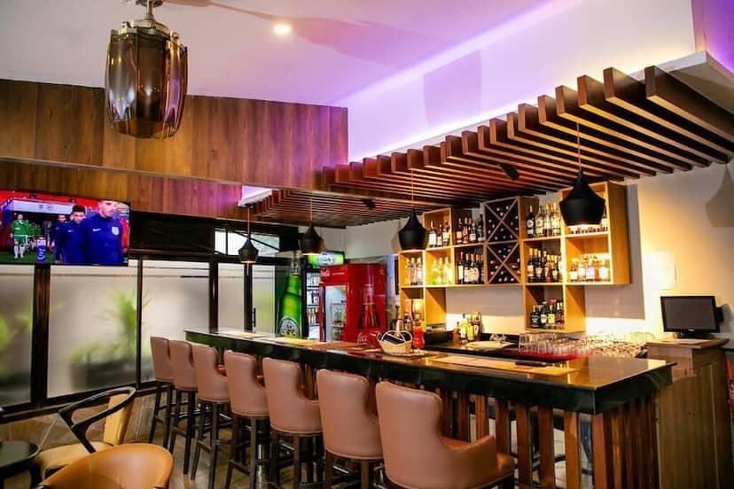 Modern conference room with bar setup, ideal for networking events and casual gatherings.