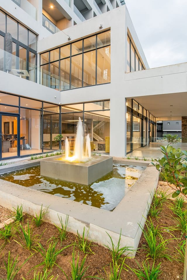 Rooftop bar in Blueberry Hill Hotel with stylish fountain, perfect for events and gatherings.
