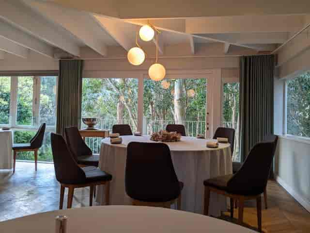 Bright dining area with round table, perfect for meetings and events in La Colombe Group.