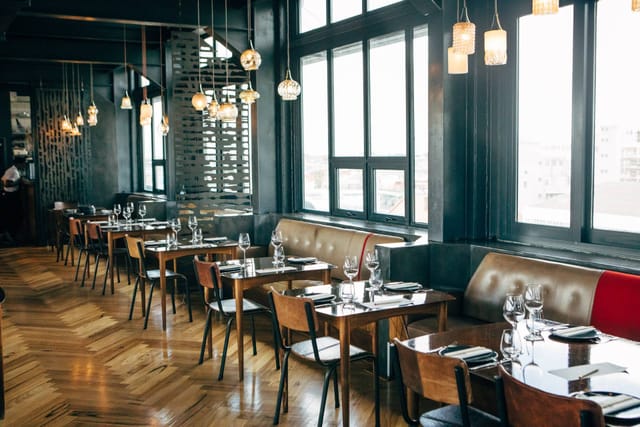 Stylish Potluck Club dining space with elegant tables, perfect for events and meetings.