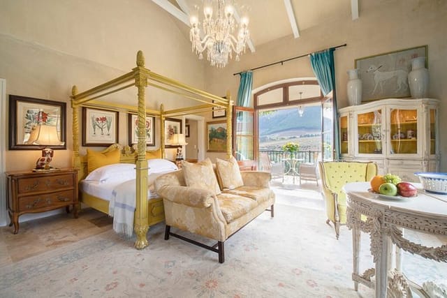 Luxurious four-poster bedroom in La Residence for intimate retreats and private events.