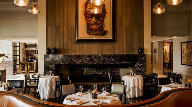 Elegant Delaire Graff Restaurant with cozy fireplace ideal for upscale events and gatherings.