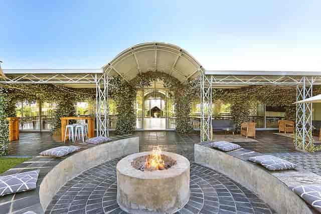 Outdoor ceremony area in Belair with cozy fire pit, perfect for events and gatherings.