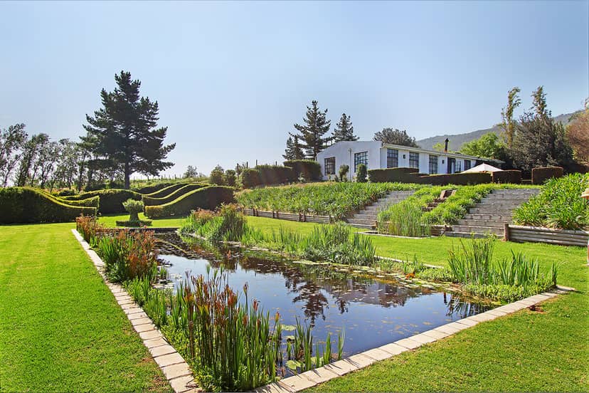 Belair Gardens outdoor venue with serene pond for events and meetings.