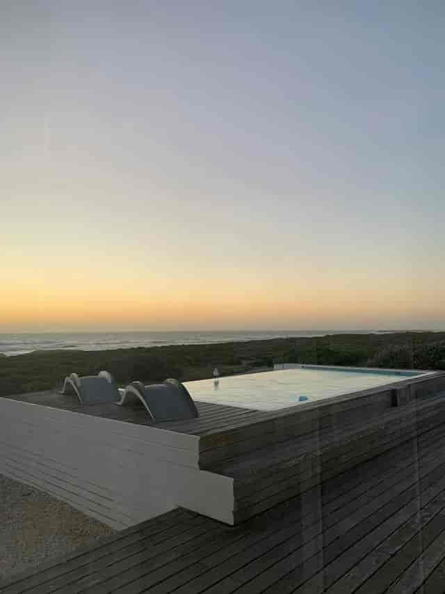 Serene beachfront infinity pool at dusk, ideal for outdoor networking events and retreats.