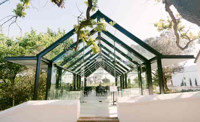 Modern glass pavilion at Hazendal Wine Estate for events and meetings.
