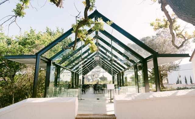 Modern glass pavilion at Hazendal Wine Estate for events and meetings.