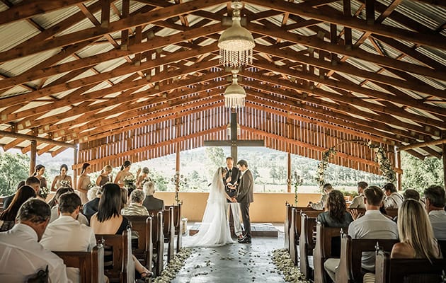 Rustic wedding ceremony at Buffet Hall, Cradle Valley with elegant decor and natural lighting.