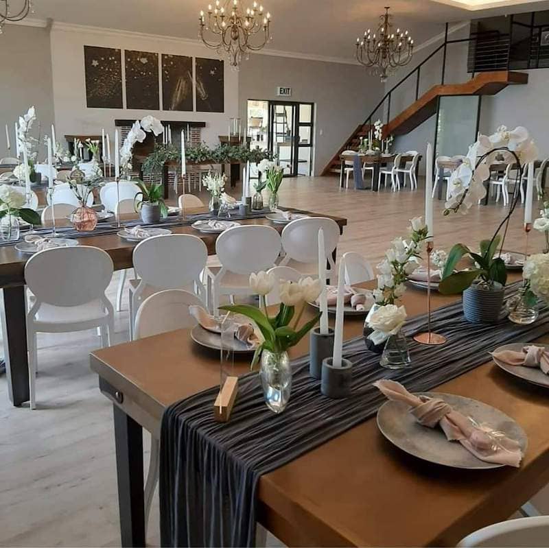 Elegant Cap Classique venue with floral centerpieces for corporate events or gatherings.