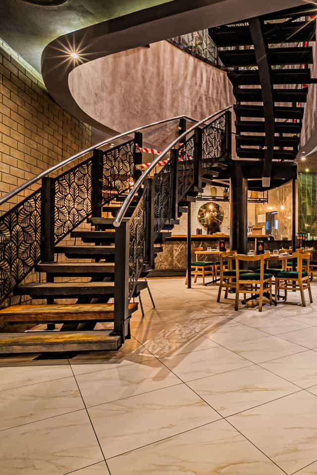 Stylish spiral staircase at Fireroom Montecasino, perfect for gatherings and events.