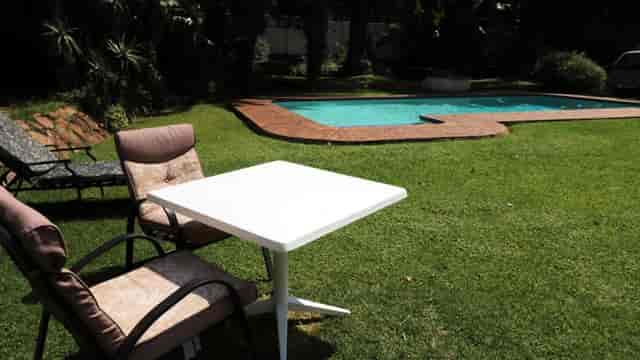 "Outdoor patio with white table at Observatory Golf Club for casual gatherings and networking."