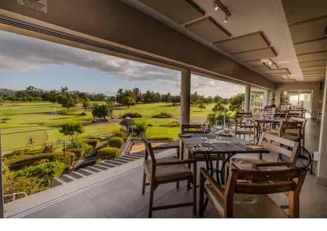Outlook Restaurant: elegant indoor dining with golf course views, ideal for events.