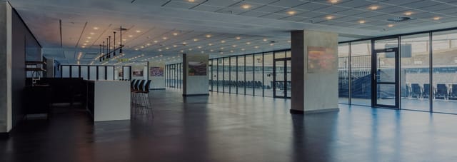 Contemporary event space in DHL Stadium with floor-to-ceiling windows, ideal for corporate events.