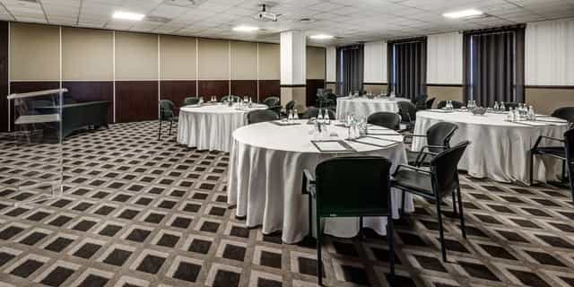 Hitchcock in 54 meeting space with round tables for professional gatherings and workshops.