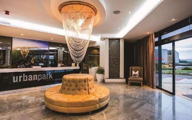 Marula Ballroom lobby at Urban Park Hotel, featuring marble floors and chandelier for events.