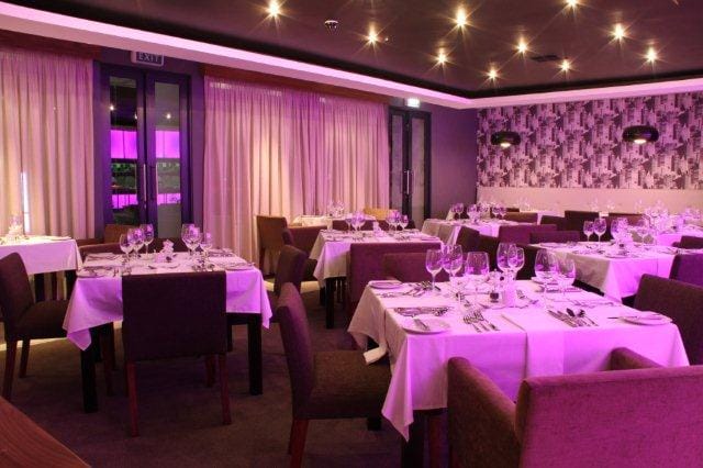 Modern dining space at Cosmopolitan Restaurant, ideal for events and networking dinners.