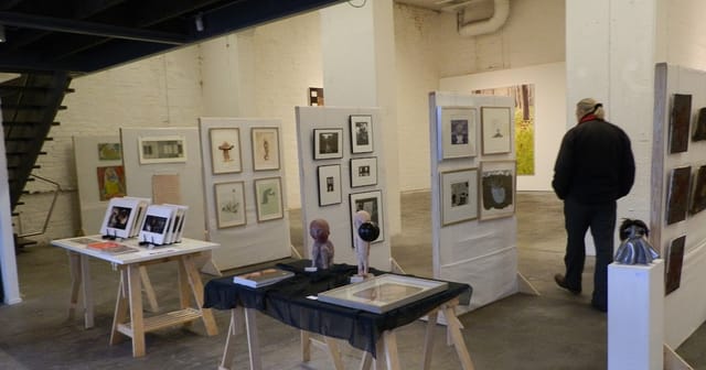 Art gallery exhibition with framed artworks and inviting layout for networking events.