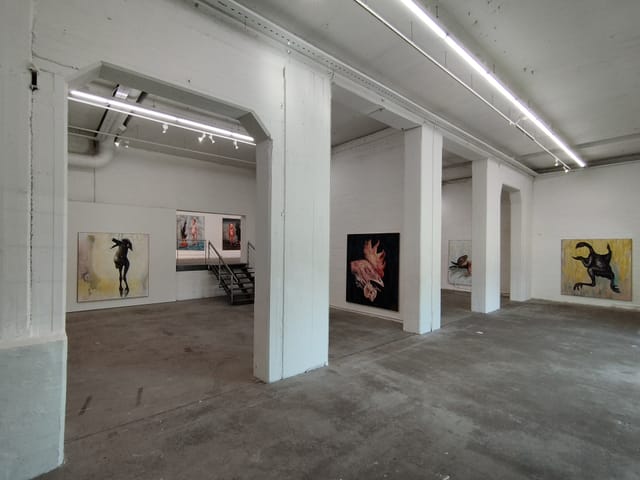 Minimalist art gallery with white walls, ideal for exhibitions and networking events.