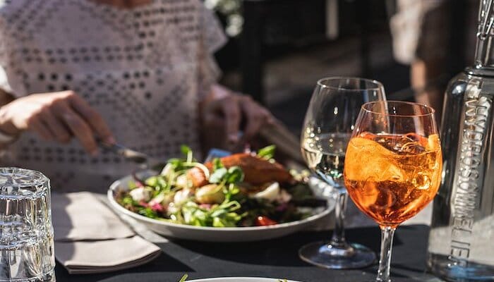 Stylish outdoor dining set-up with fresh food, perfect for networking lunches and receptions.