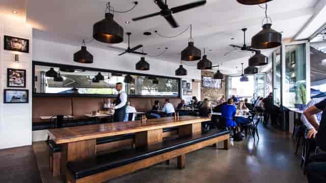 Modern dining space at Il Molo with pendant lighting, perfect for events and meetings.