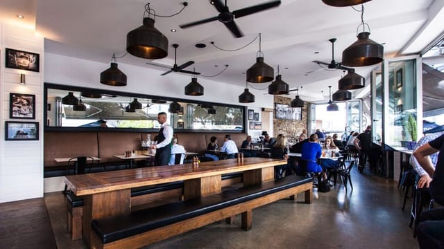 Modern dining space at Il Molo with pendant lighting, perfect for events and meetings.