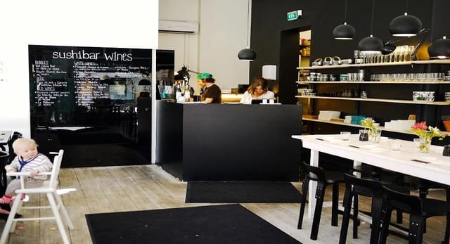 Modern minimalist restaurant with inviting bar, perfect for casual events and meetings.