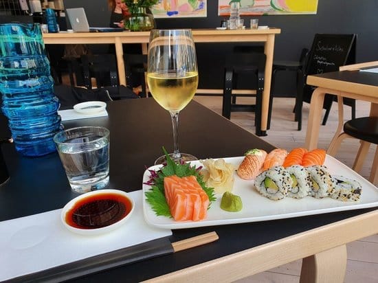 Upscale sushi plate with wine, perfect for corporate lunches and networking events.