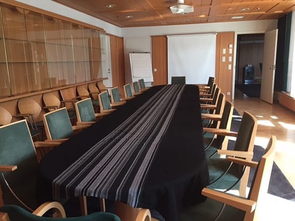 Elegant conference room with a long table, ideal for meetings and events.