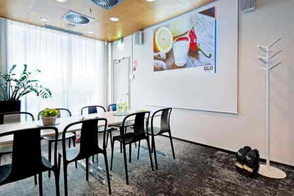 Modern meeting room with sleek table, ideal for business presentations and workshops.