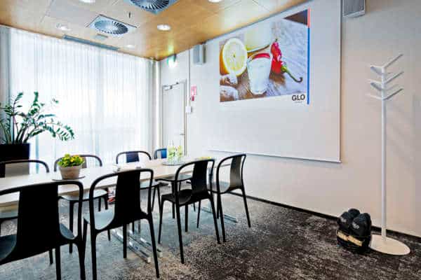 Modern meeting room with sleek table, ideal for business presentations and workshops.