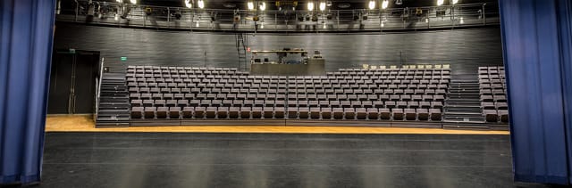 Theatre Hall auditorium with tiered seating, ideal for events and performances.