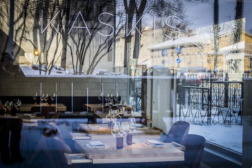 Stylish Kaskis Restaurant with polished wood tables, ideal for upscale events and gatherings.
