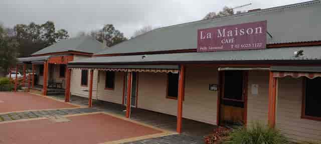 "Charming La Maison Café with rustic exterior for intimate events and meetings."