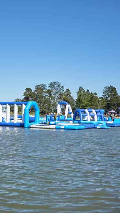 Vibrant inflatable water obstacle course for summer team-building events.