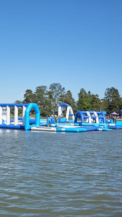 Vibrant inflatable water obstacle course for summer team-building events.