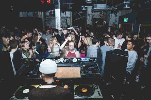 Lively nightclub scene in SOUP Manchester with dancing crowd and DJ setup, nightlife event.