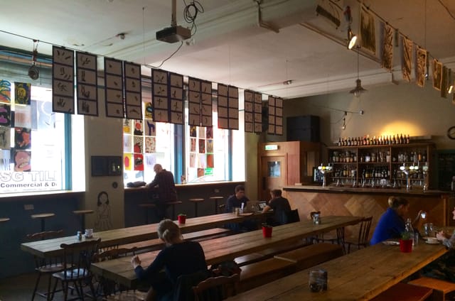 Spacious SOUP Manchester bar with communal tables for casual meetings and events.